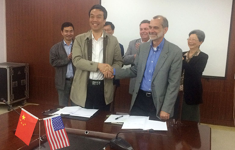 Wu Chundu, President of Yangzhou Polytechnic College and Jeff Wagnitz, Vice President of Academic Affairs for Highline College (acting president at the time of this photo) sign the Memo of Understanding regarding the partnership between the two schools.